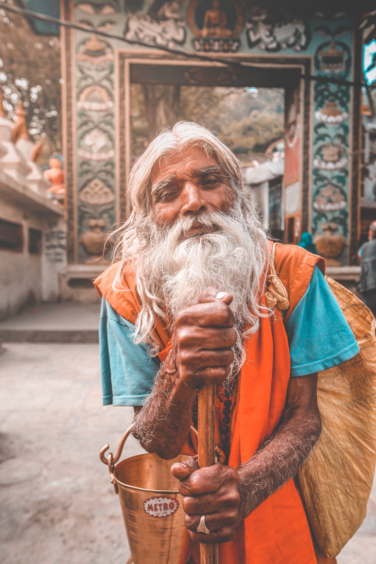 A Hindu priest in front of a Nepalese temple, immersed in the rich cultural experience of Nepal, while savoring the unique qualities of its hallucinogenic honey.